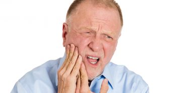 Senior man having a tooth ache