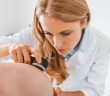Dermatologist examines skin of patient