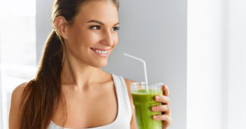 woman drinking fresh green vegetable shake for detox
