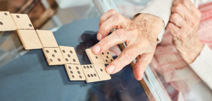 Old woman playing domino games